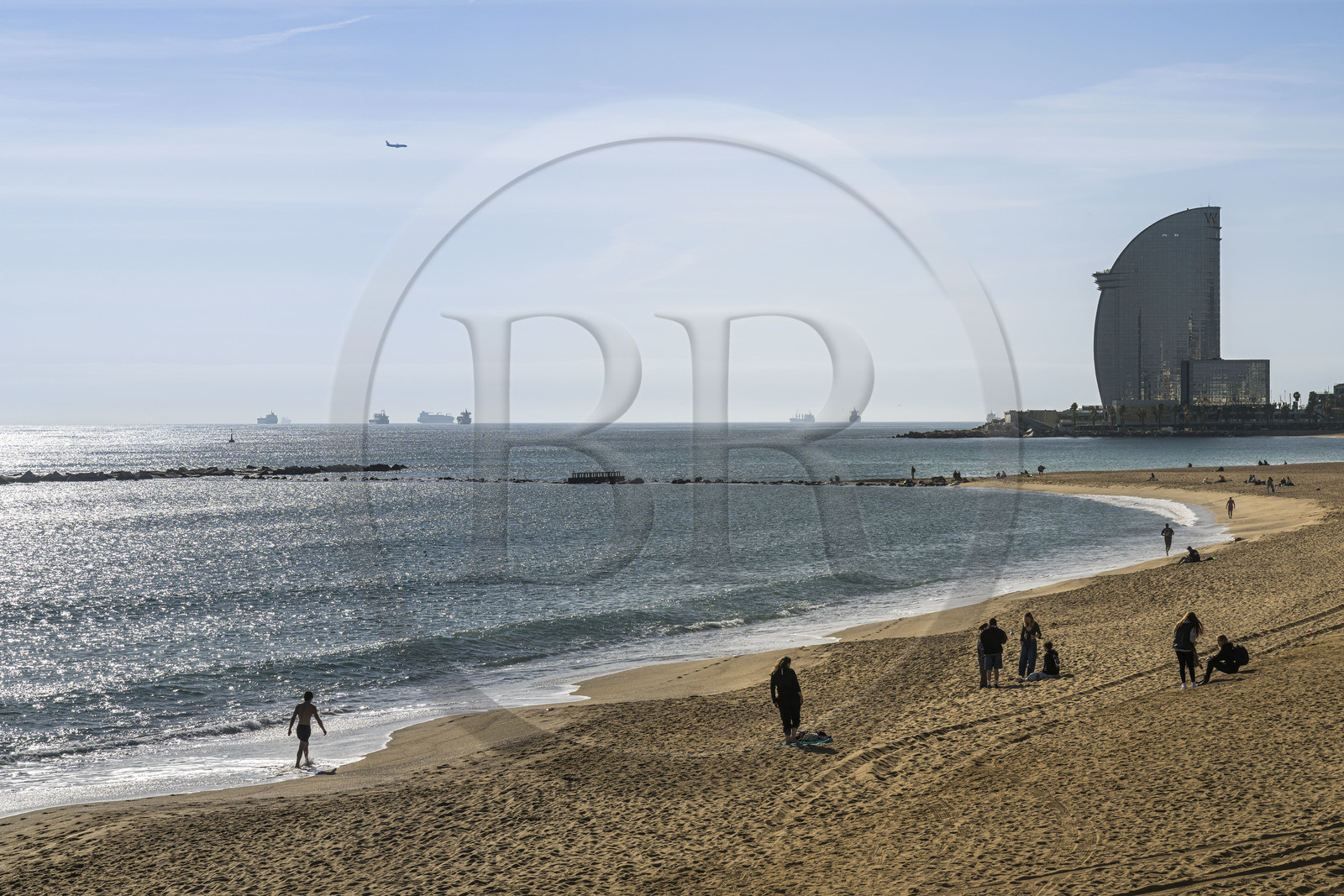 Spain, Catalonia, Barcelona, La Barceloneta, the beach and the Hotel W Barcelona by architect Ricardo Bofill on the seafront in the background