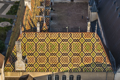 France, Cote d'Or, Beaune, area listed as World Heritage by UNESCO, Hospices de Beaune, Hotel Dieu, the roofs covered with glazed and colored tiles (aerial view)