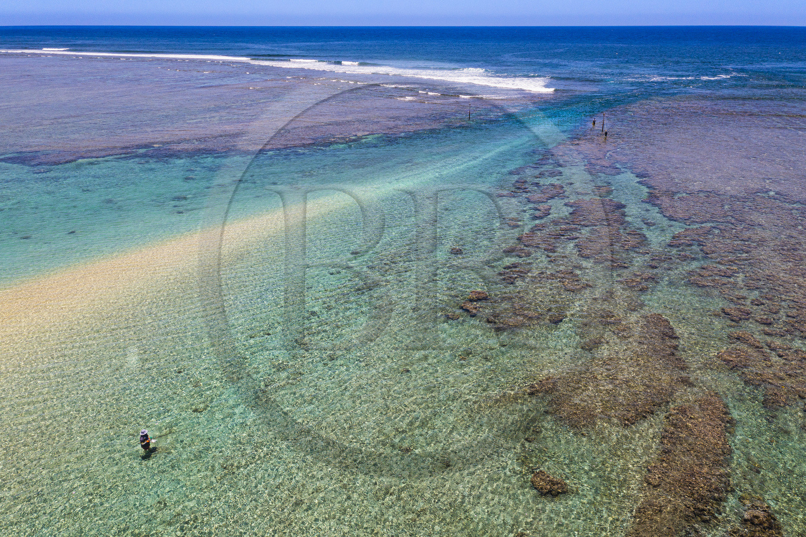 France, Reunion Island (French overseas department), West Coast, Saint Gilles les Bains lagoon beach at Ermitage les Bains, fishermen in the lagoon and shark nets across the Passe de l'Ermitage in the background (aerial view)