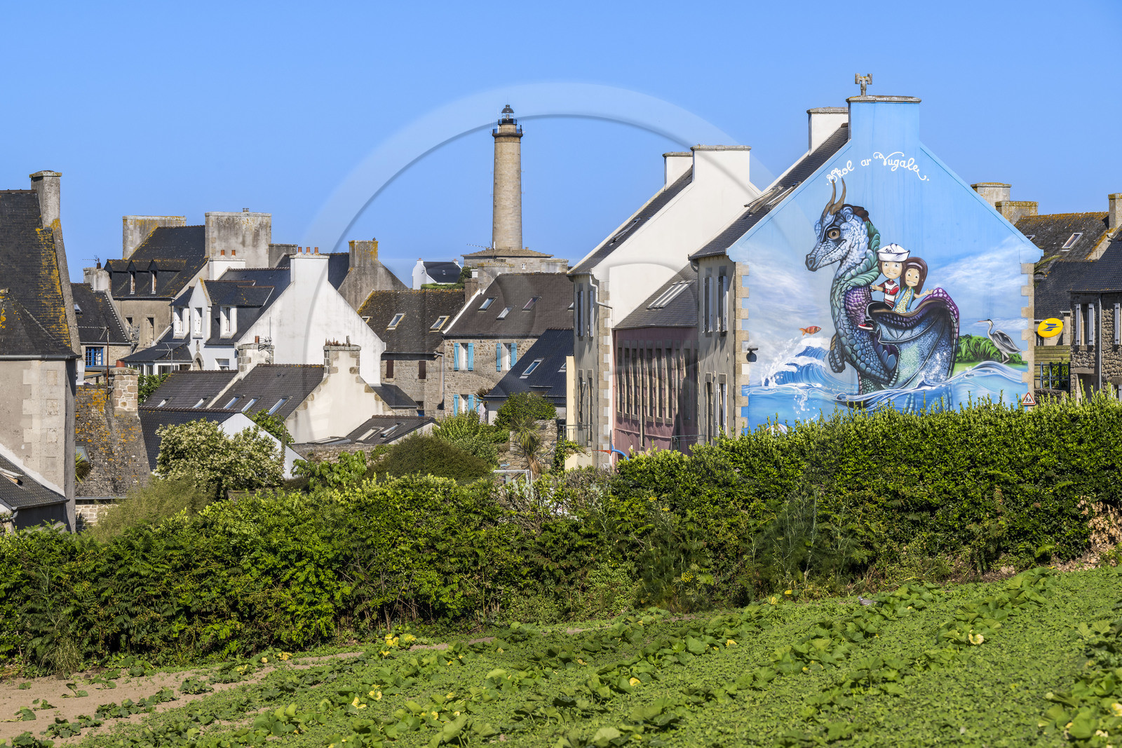 France, Finistère (29), Iles du Ponant, Ile de Batz, peinture murale des street-artistes Zag et Anje reprenant la légende du dragon sur un mur du bureau de la Poste et le phare en arrière plan