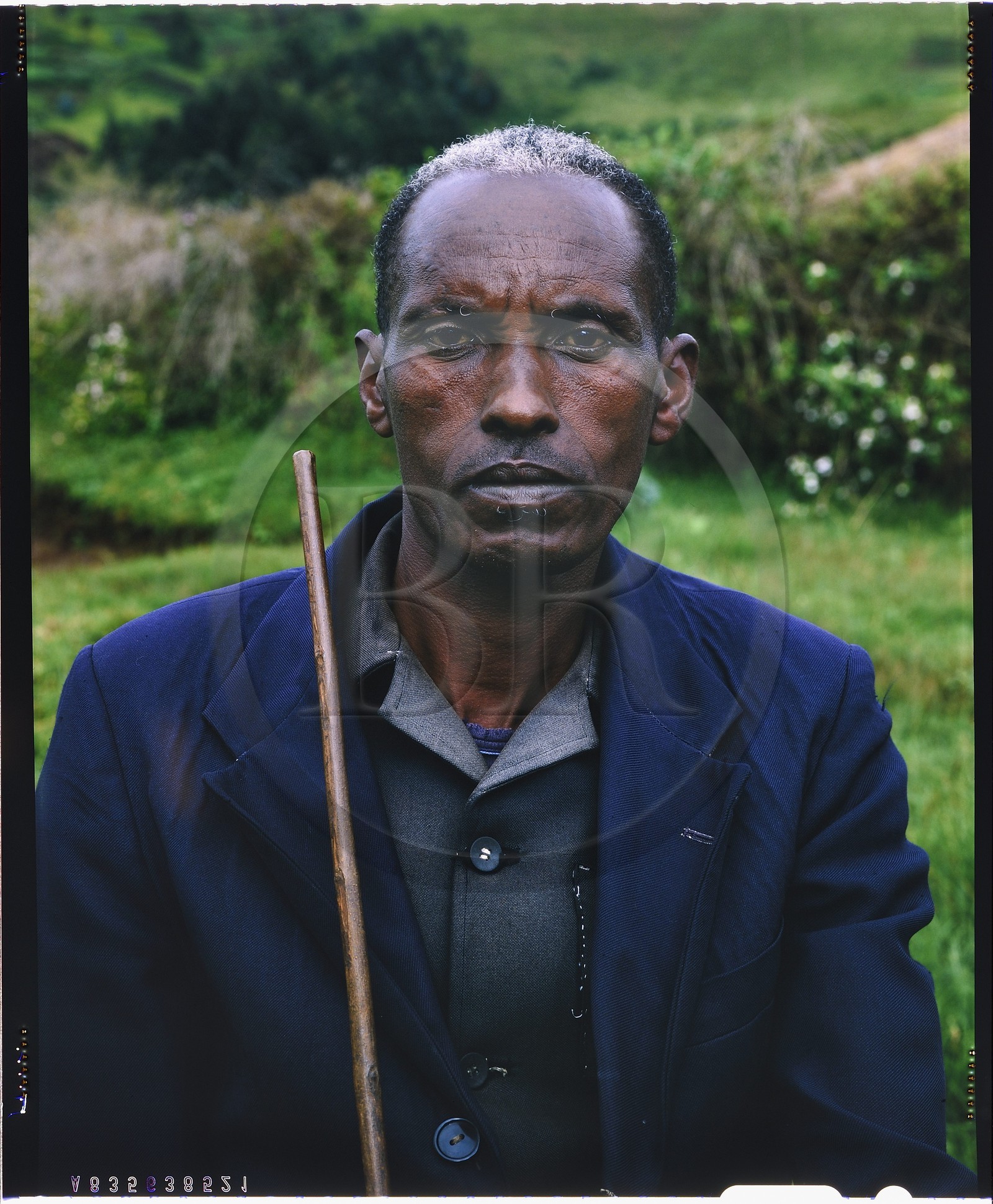 Burundi, Bujumbura Province, Ijenda area, Tutsi family head, whether traditional clothing of beaten wood bark are long gone, the pose, proud and almost condescending, remains the same, in the very traditionalist region of Ijenda, Burundian never go out without having in hand a long stick even if once they sometimes preferred the spear (4x5 reversal film reproduction)