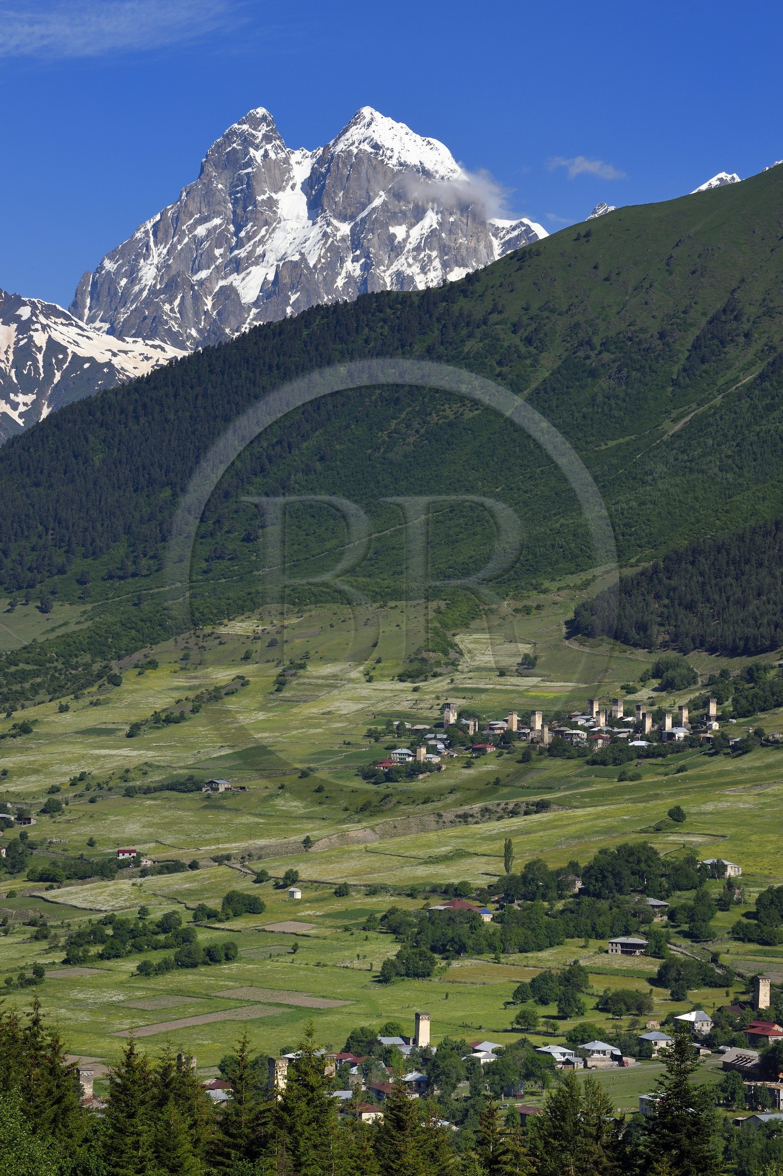 Georgia, Upper Svaneti (Zemo Svaneti), Mestia region, village of Mulakhi, Svan defensive towers and Mount Ushba in the background