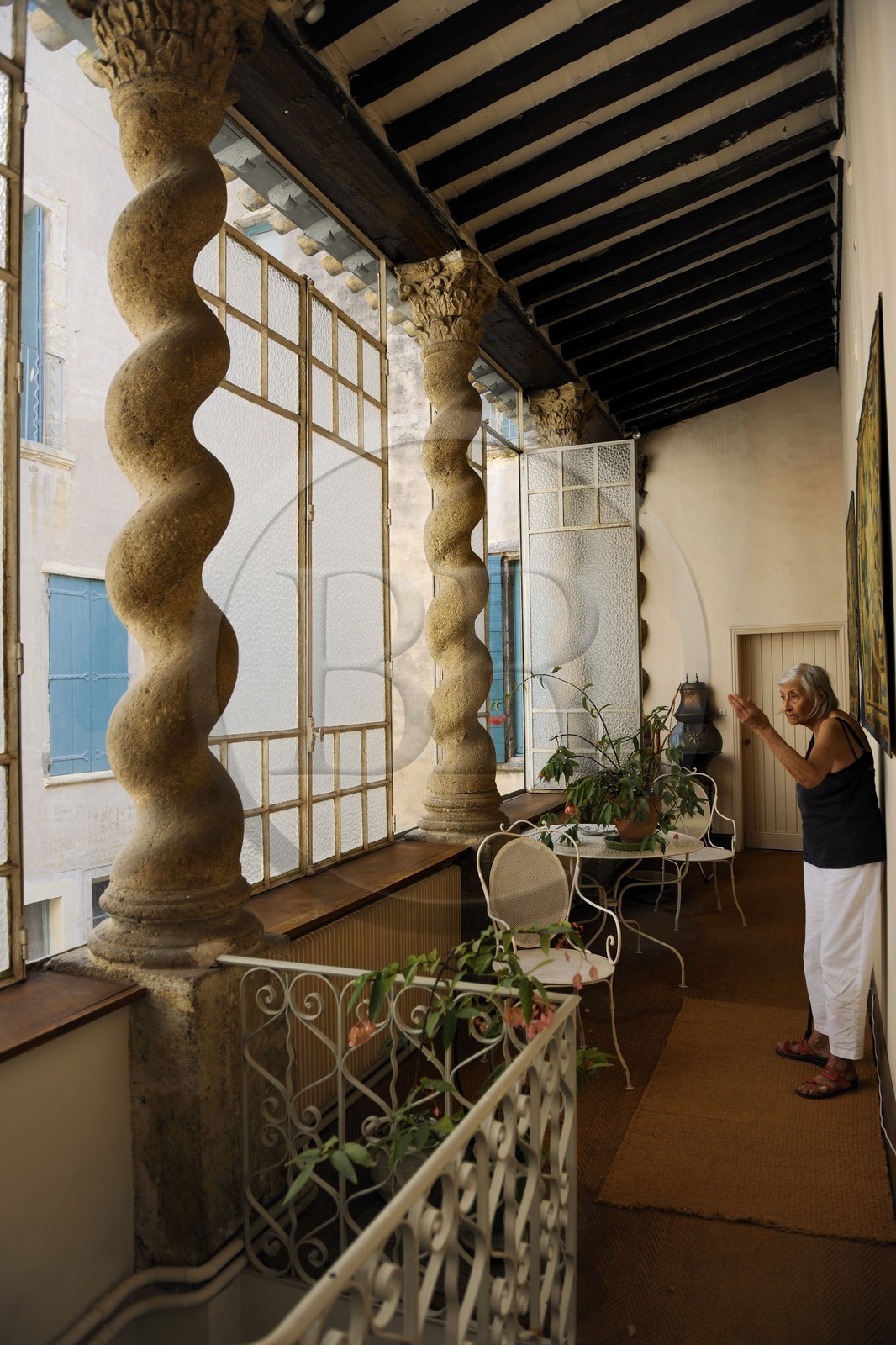 France, Hérault (34), Pézenas, Hôtel d'Alfonse du 17éme siècle rue Conti où Molière et sa troupe donnèrent «le Médecin Volant», la propriétaire madame Aubert devant les colonnes torses monolithes à chapiteaux corinthiens qui soutiennent un toit en appentis