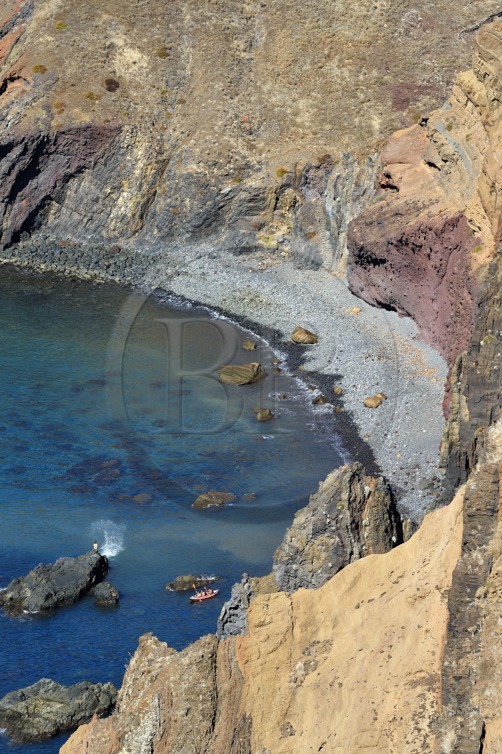 Portugal, Madeira Island, hike in the Ponta de Sao Lourenço nature reserve in the far east of the island, kayak going away from the pebble beach in Abra Bay