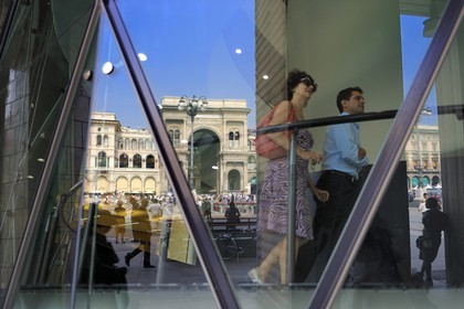 Italy, Lombardy, Milan, Piazza del Duomo, entrance of the Galleria Vittorio Emanuele II as reflected in a window of the museum del Novecento (1900)