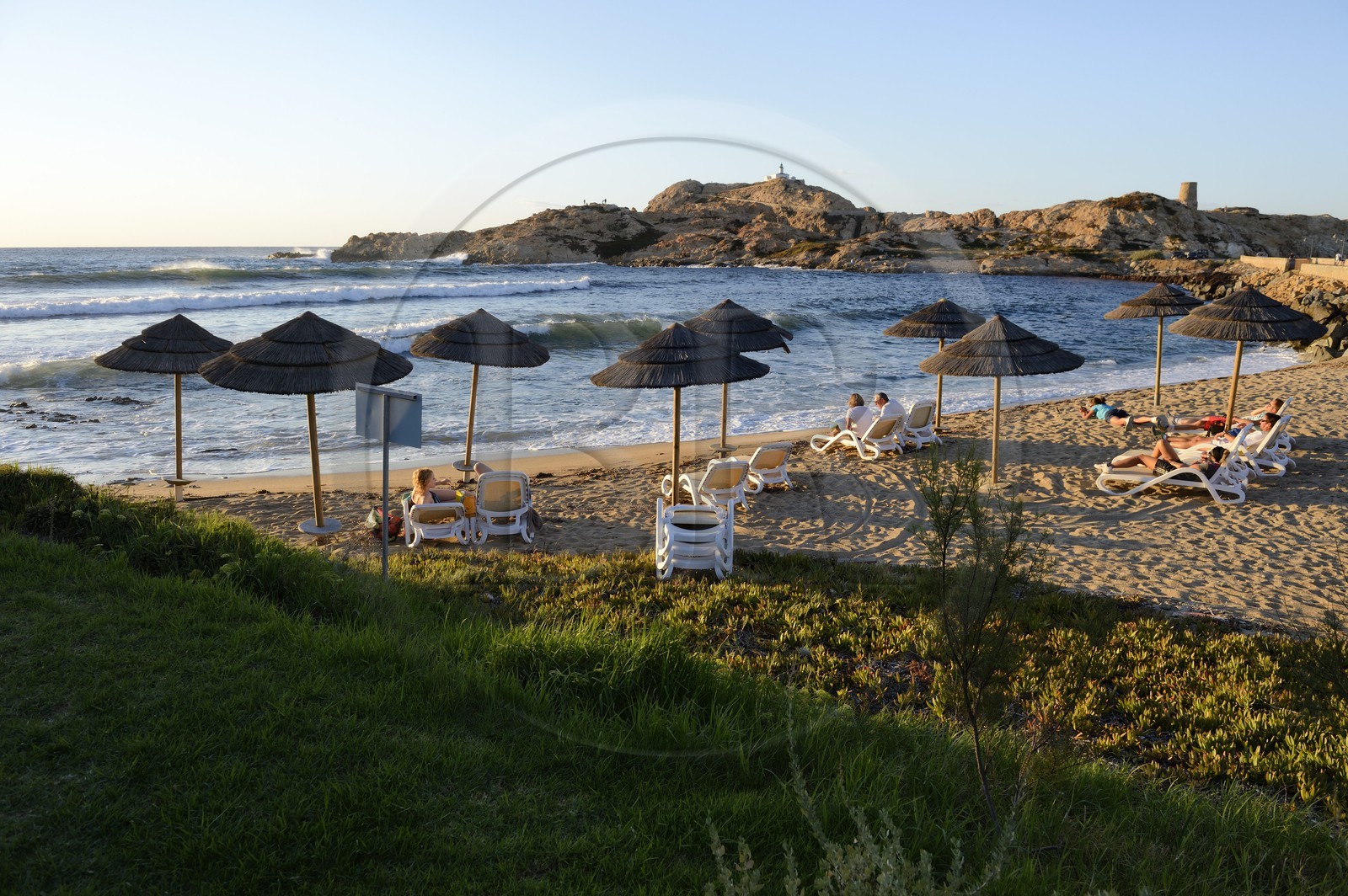 France, Haute Corse, Balagne, L'Ile Rousse, the Pietra Lighthouse and the fifteenth century Genoese tower behind the beach