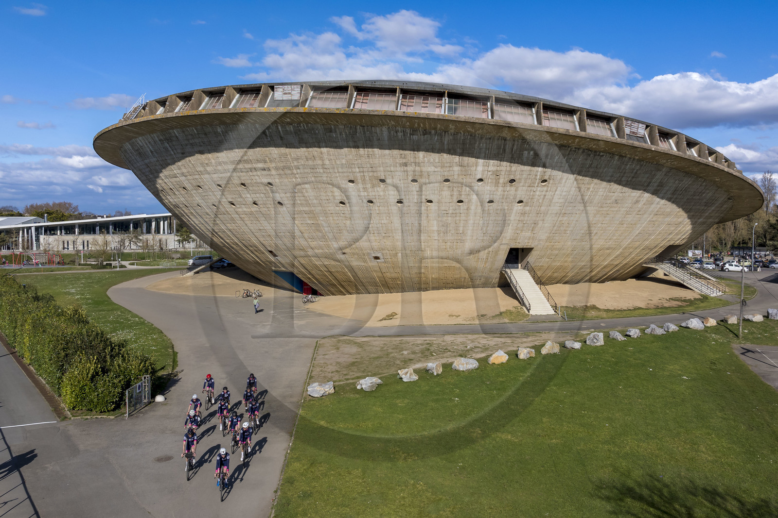 France, Loire-Atlantique, Saint-Nazaire, the Sports Palace called La Soucoupe dating from the reconstruction of the city and cyclists from the Best Triathlon Saint Nazaire club in training (aerial view)