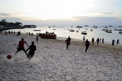 Tanzania, Zanzibar Archipelago, Unguja island (Zanzibar), Stone Town, listed as World Heritage by UNESCO, fooball players on the beach