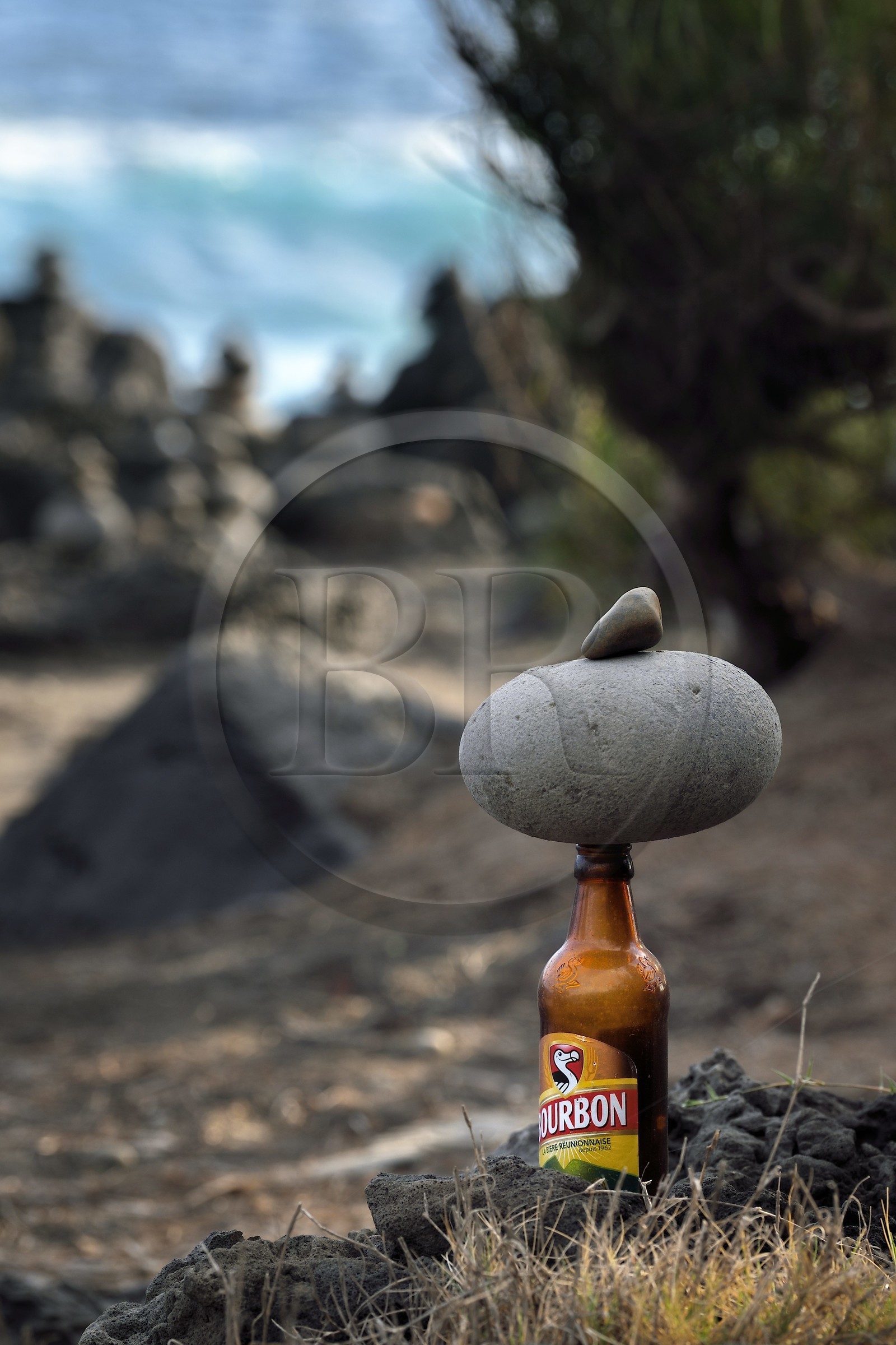 France, Ile de la Reunion, L'Etang Salé les Bains, la côte entre Le Gouffre et l'Etang du Gol, cairn de galets et d'une bouteille de bière bourbon dite Dodo