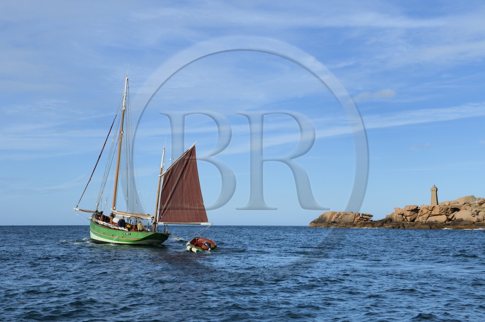 France, Cotes-d'Armor, Cote de Granit Rose (the Pink Granite coast), Perros Guirec, Ploumanach, Pointe de Squewel and Mean Ruz Lighthouse, the traditional sailboat Sant C'hireg (Saint Guirec)