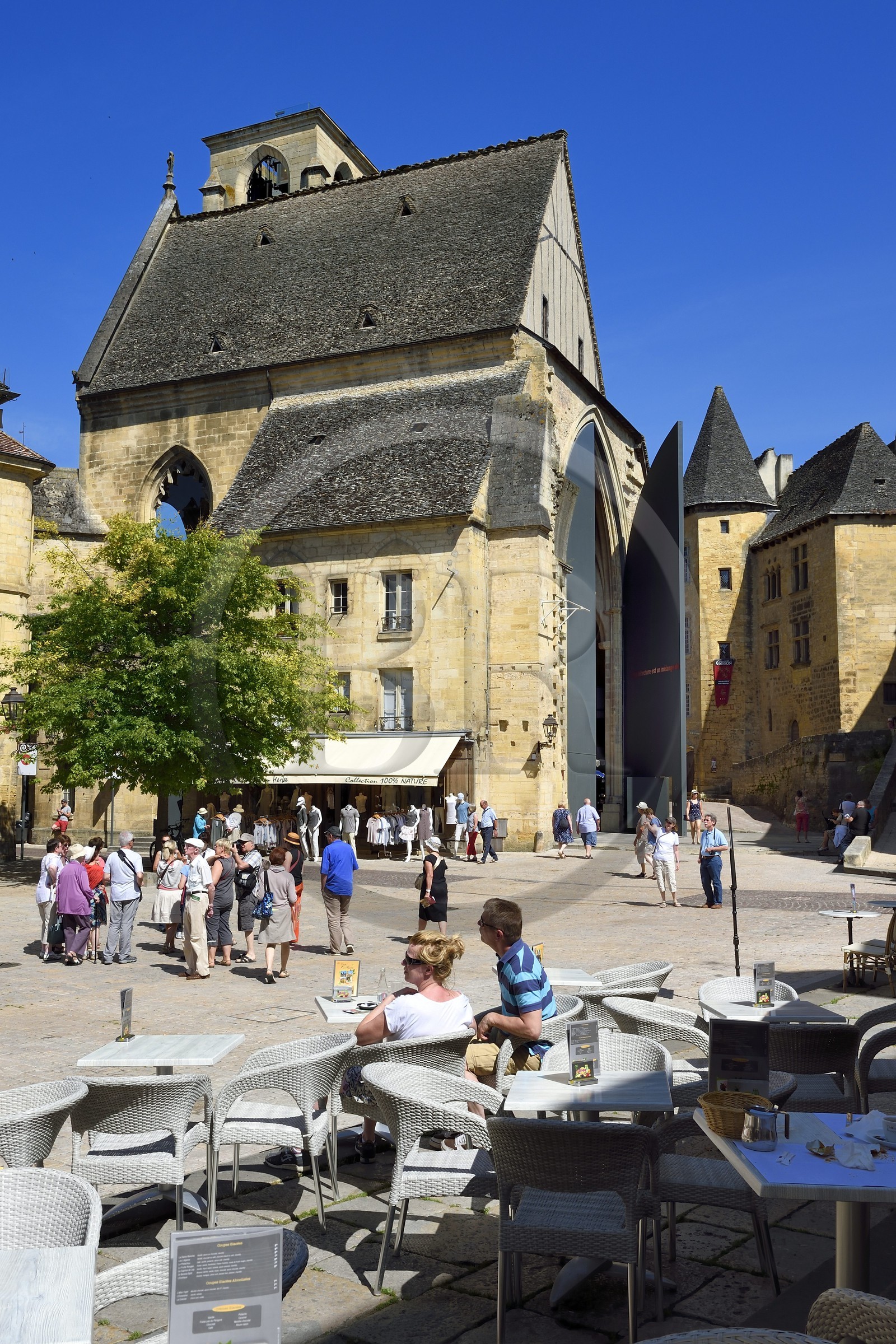 France, Dordogne, Perigord Noir, Dordogne valley, Sarlat la Caneda, Place de la Liberte, cafe terrace and Ste Marie old church in the background