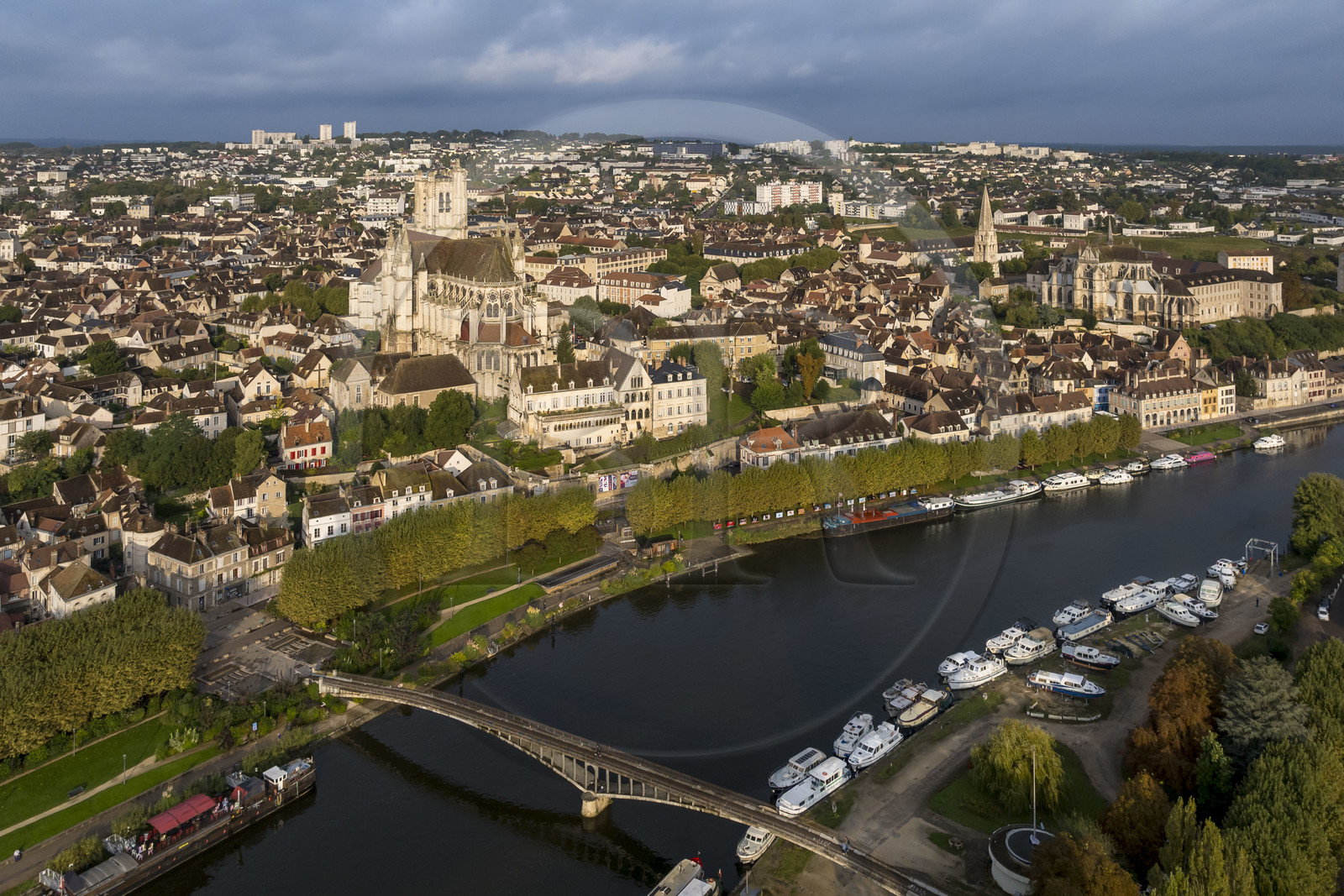 France, Yonne, Auxerre, Saint Etienne Cathedral and Saint Germain Abbey on the right, the Green belt cycle path along the Yonne on the quay facing the port, the barge La Scène des Quais moored at the foot of the Passerelle de la Liberté in the foreground (aerial view)