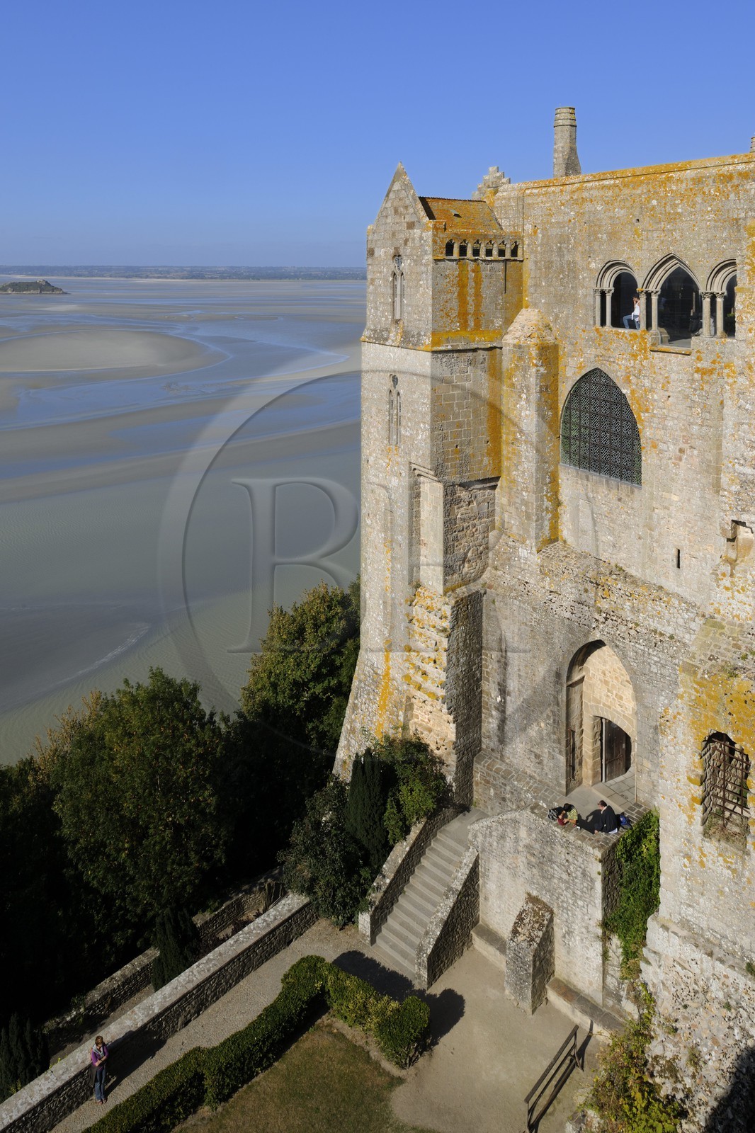 France, Manche, the abbey of Mont Saint Michel, listed as World Heritage by UNESCO, the north buildings (cloister, the knights room) overlooking the bay at low tide