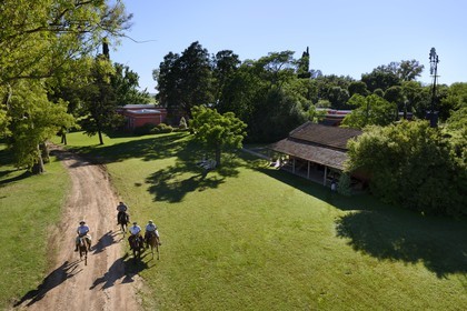 Argentina, Buenos Aires Province, San Antonio de Areco, group of gauchos on horseback in front of the estancia La Bamba de Areco