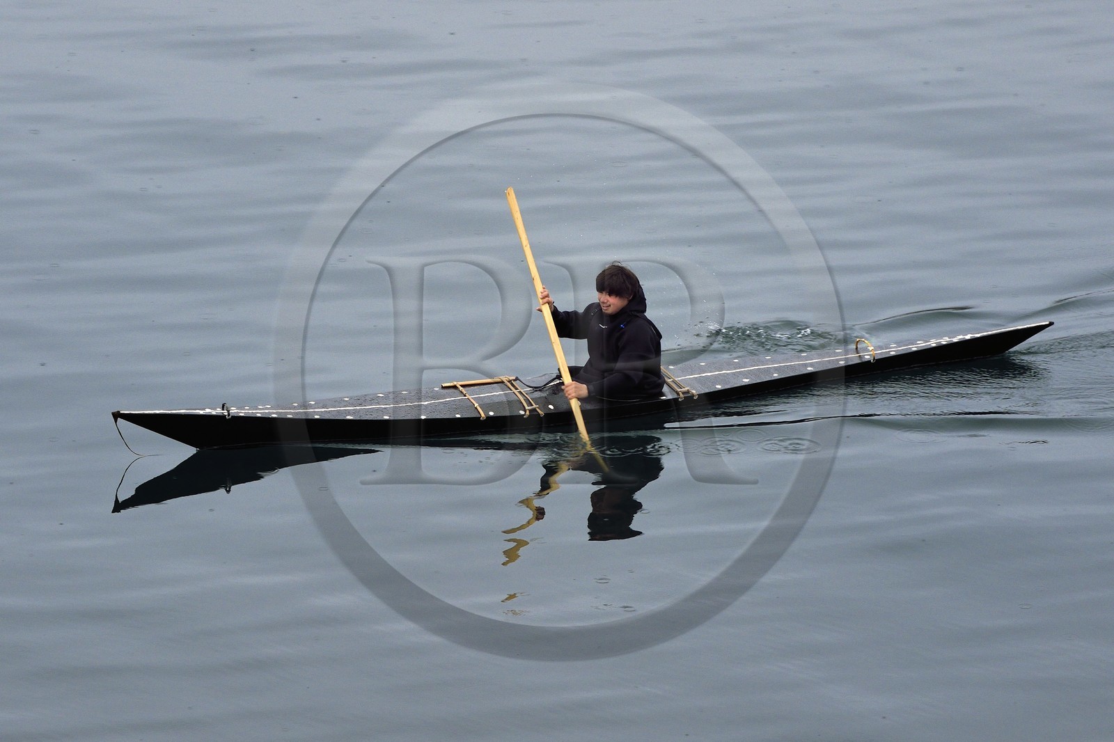 Greenland, central western region, Sisimiut (formerly Holsteinsborg), Inuit in a traditional kayak