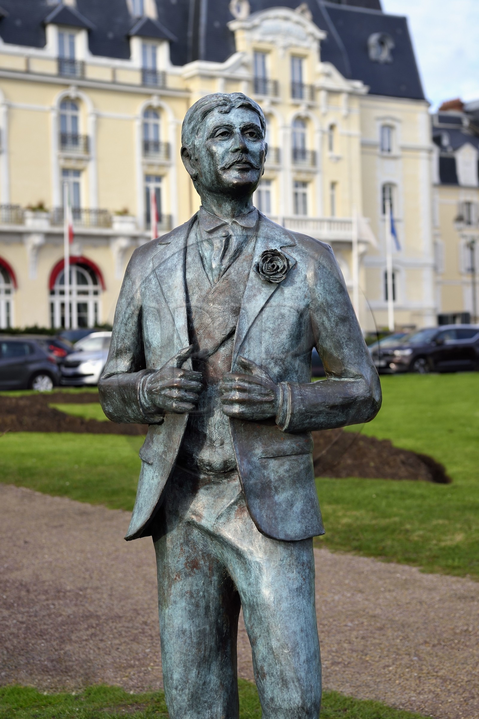France, Calvados, Pays d'Auge, the cote Fleurie (Flowered coast), Cabourg, statue of Marcel Proust by Edgar Duvivier in the gardens of the Casino and the Grand Hotel (in the background)