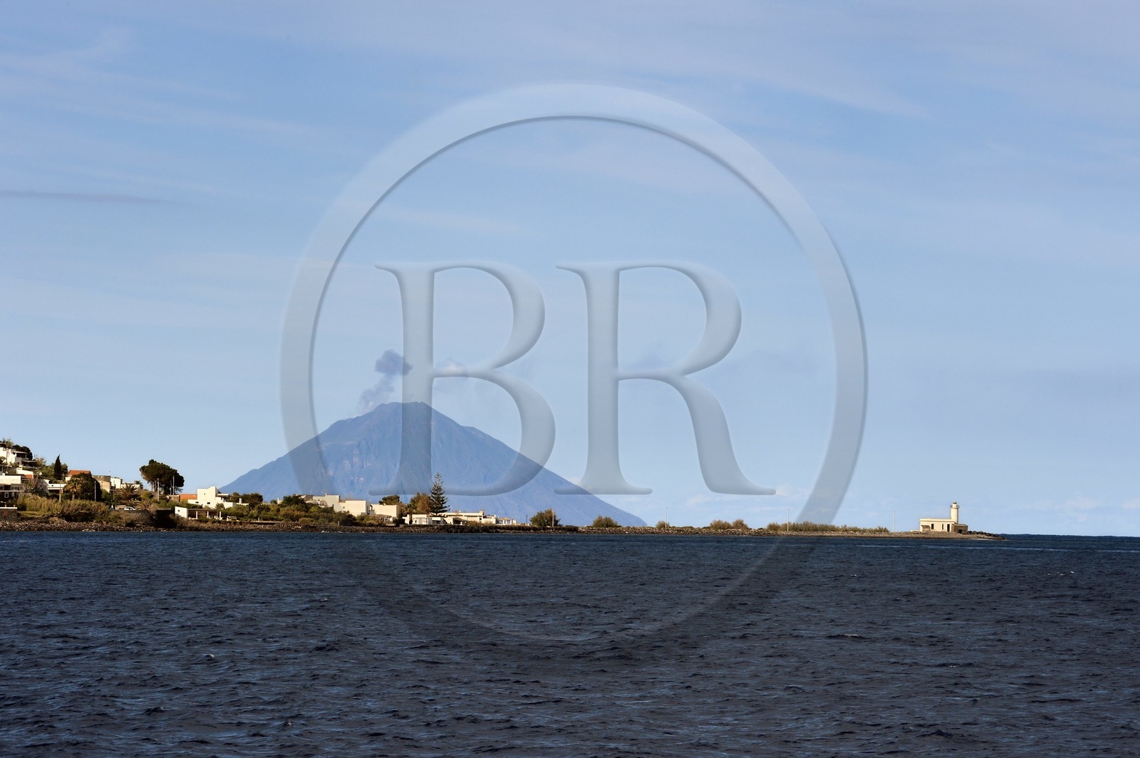 Italy, Sicily, Aeolian Islands, listed as World Heritage by UNESCO, Lighthouse of the village of Lingua on Salina Island, the Stromboli volcano in the background