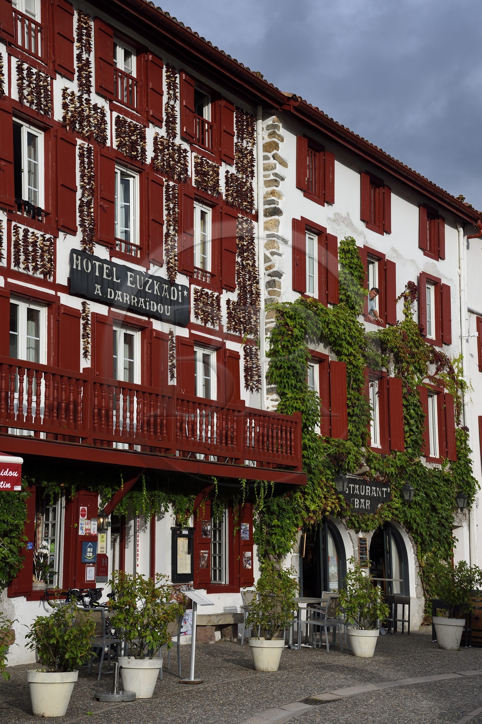 France, Pyrenees Atlantiques, Basque Country, Espelette, drying of Espelette peppers on the facades of village houses, the Euzkadi Hotel