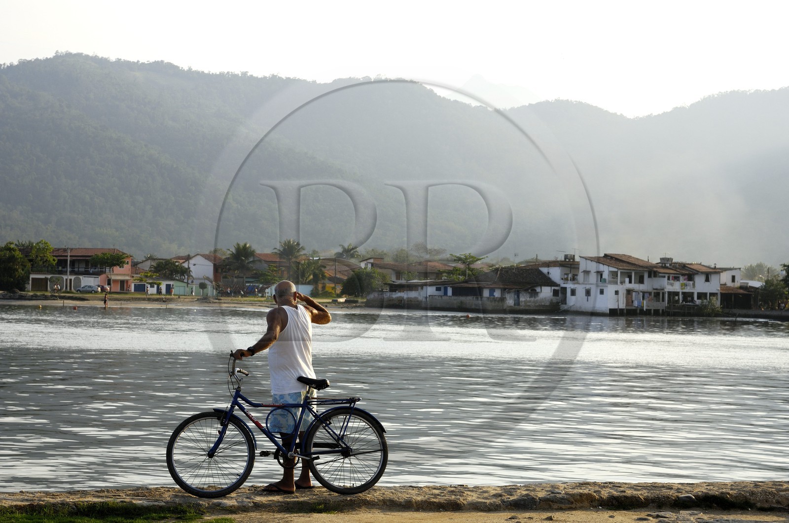 Brazil, Rio de Janeiro State, Paraty, colonial town founded in 1667 to export gold to Europe, cyclist on the port (Gold Route, Estrada Real)