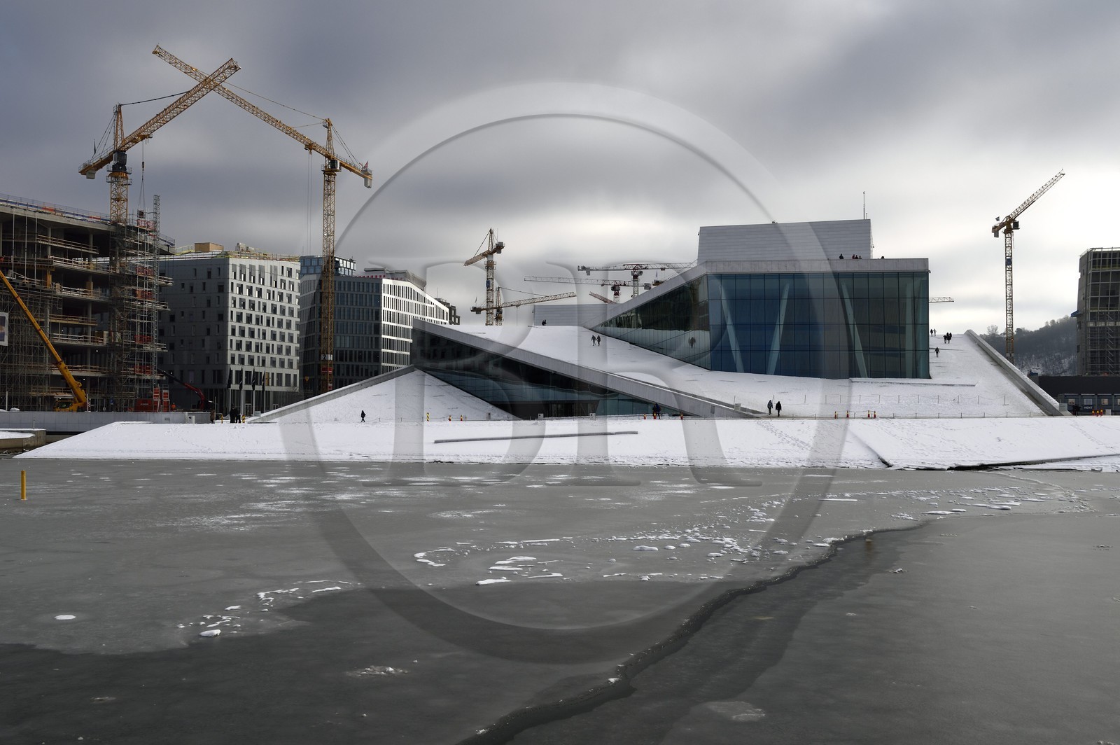 Norway, Oslo, the Opera under the snow, designed by the architecture firm Snohetta (including Tarald Lundevall) on the commercial and industrial port of Bjorvika district undergoing restructuring