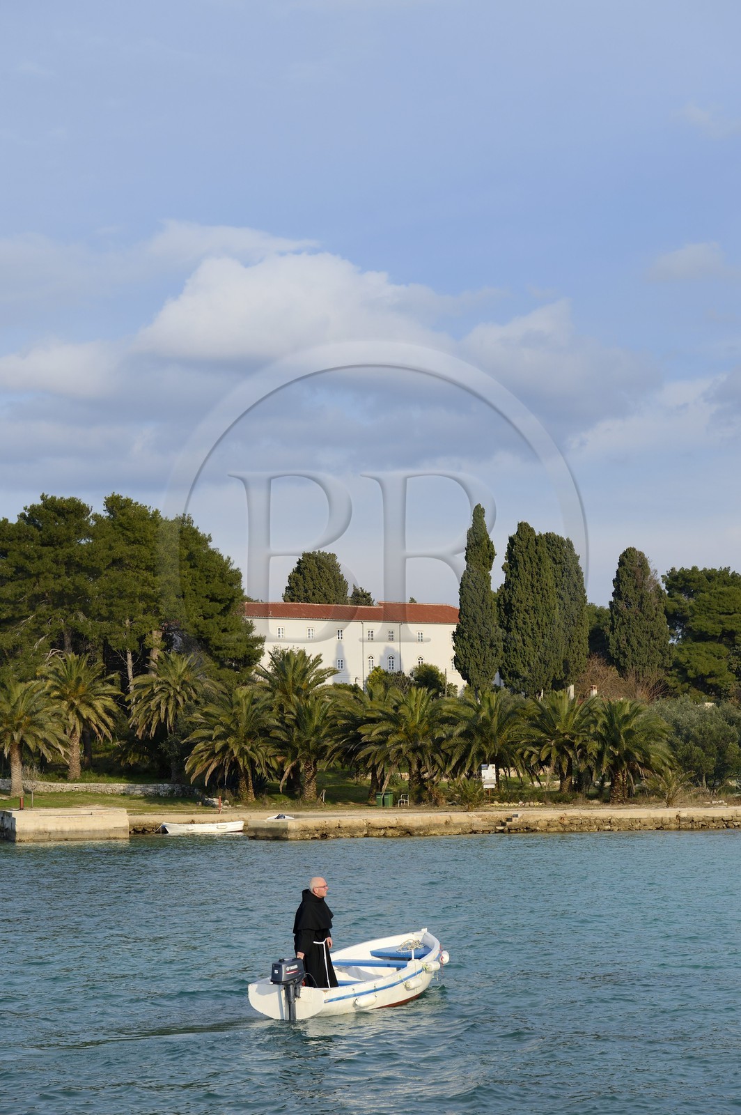 Croatia, Dalmatia, Dalmatian Coast, Ugljan Island, Preko, Franciscan friar Bozo Susic rejoining the Franciscan Monastery of the Galovac island on his boat