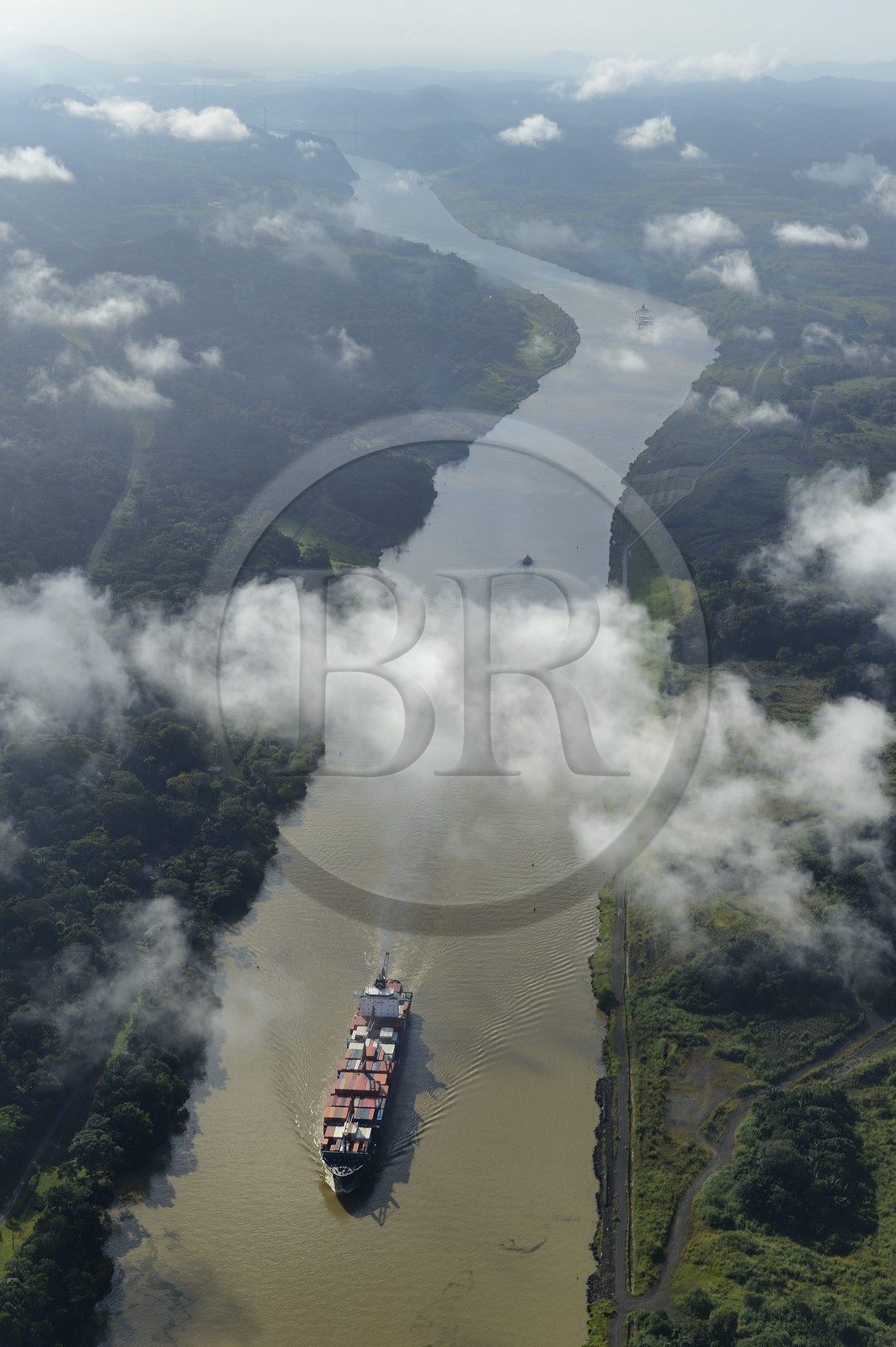 Panama, Panama Canal, a Panamax container cargo uses the Gaillard cut (or Culebra cut) between the Pedro Miguel locks on the Pacific side and the Chagres river leading to Gatun Lake (aerial view)