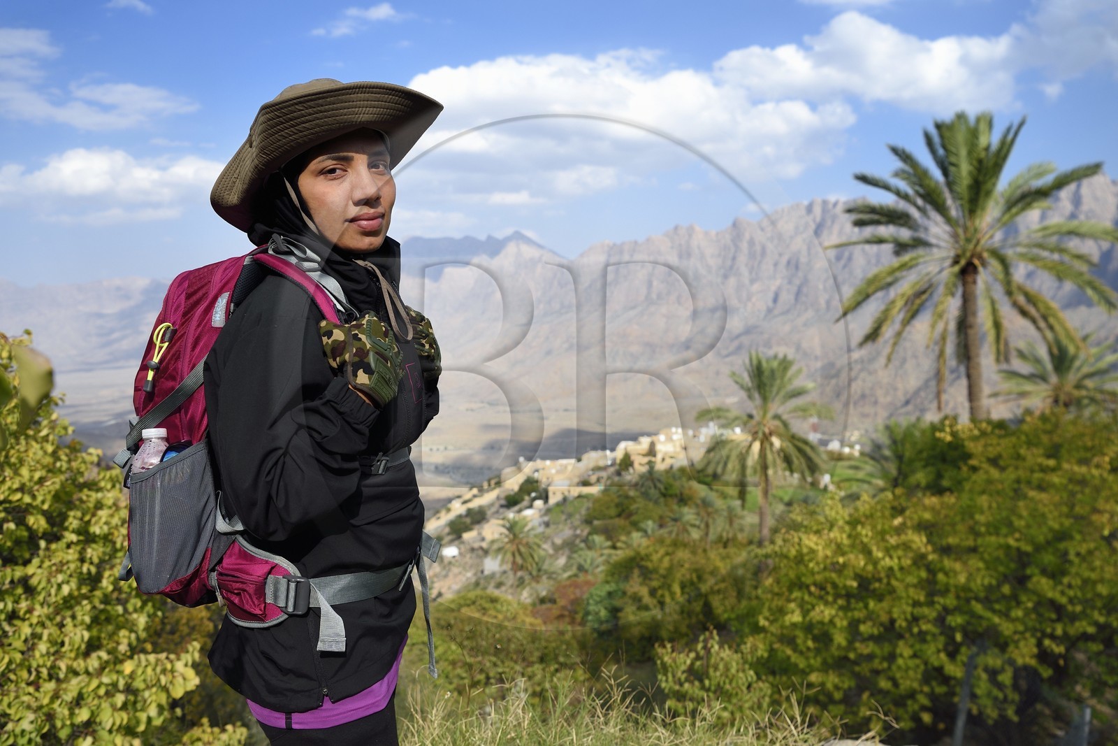 Sultanate of Oman, South Batinah Governorate, Western Hajar, Wadi Mistall, the hiker Badour Al Salhi in the terraced crops overlooking the village of Wakan (Wukan)
