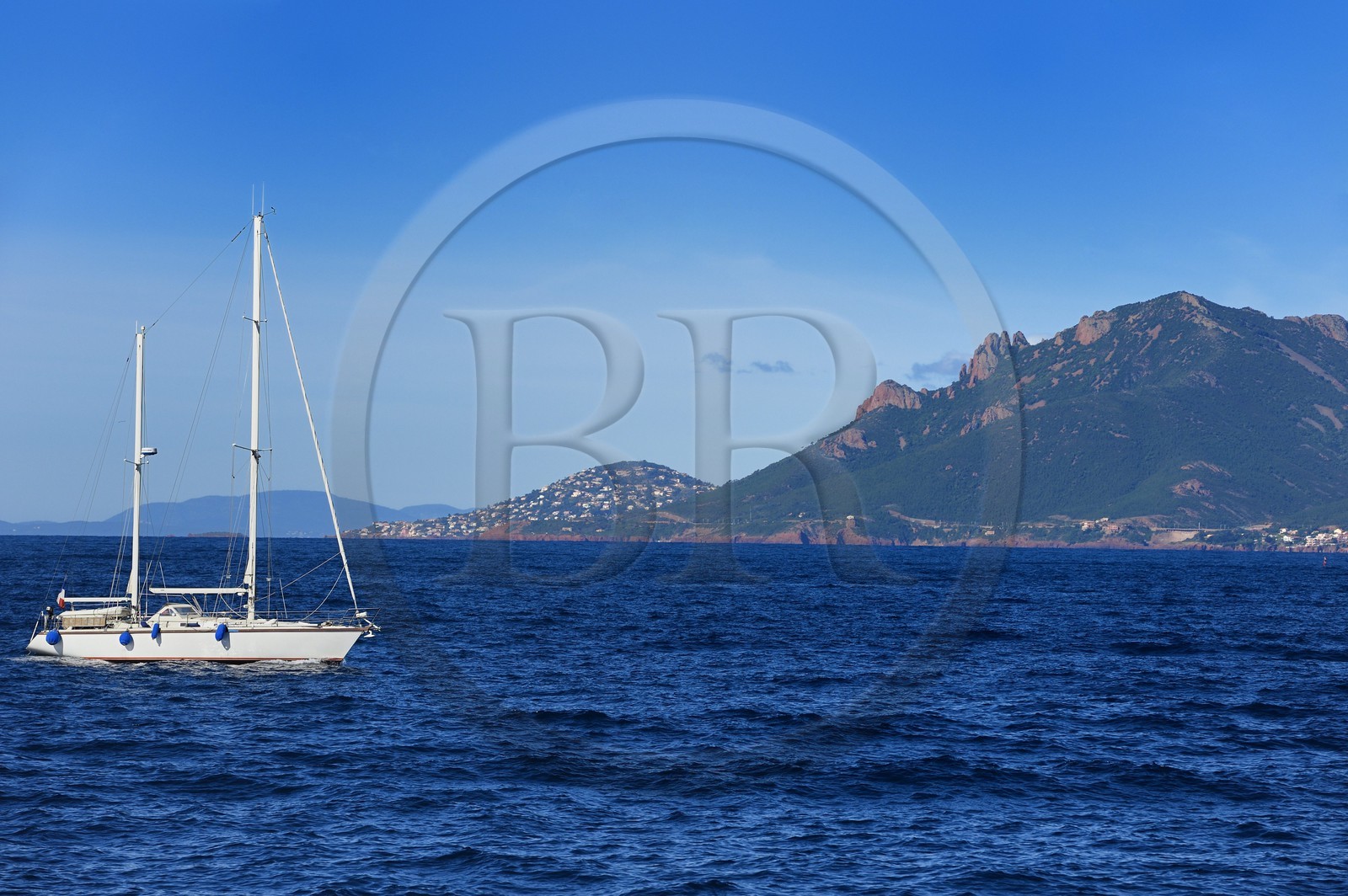 France, Alpes-Maritimes, sailboat off the Lerins Islands and the Esterel Mountains in the background