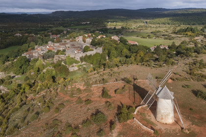 France, Aveyron, Causses and the Cévennes, cultural landscape of Mediterranean agro-pastoralism, listed as World Heritage by UNESCO, La Couvertoirade, labelled Les Plus Beaux Villages de France (The Most Beautiful Villages of France), fortified village on the Larzac plateau overlooked by the Moulin de Redounel (aerial view)