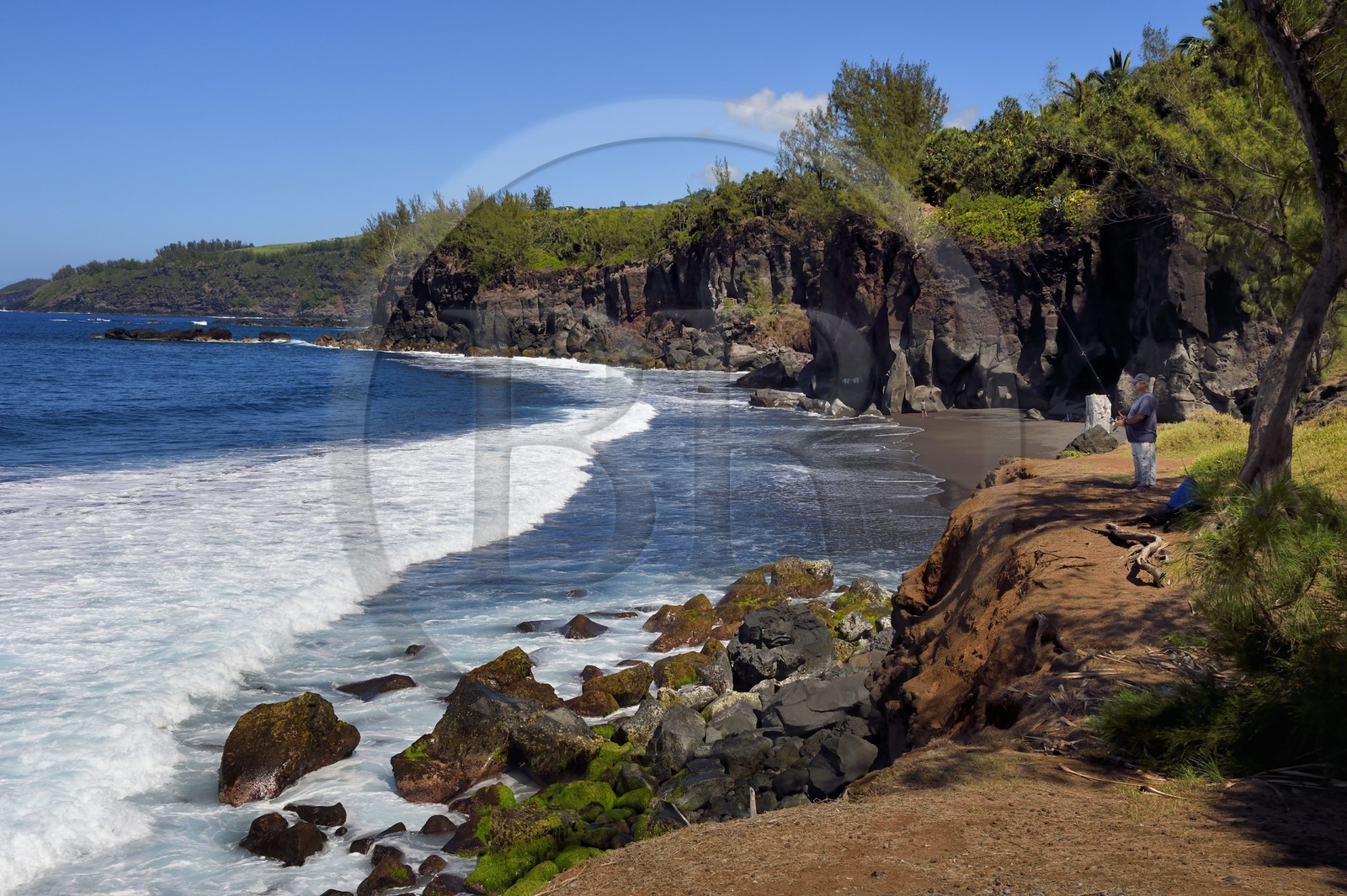 France, Ile de la Reunion, Saint-Joseph, plage de Ti Sable, plage de sable noir bordée par une falaise de lave volcanique, pecheur à la ligne