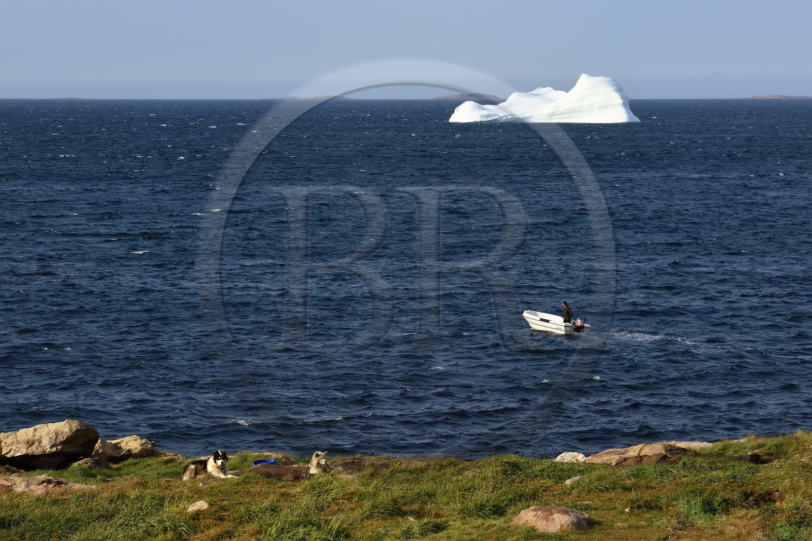 Greenland, west coast, Baffin Bay, Upernavik, departure by boat for hunting and iceberg in the background