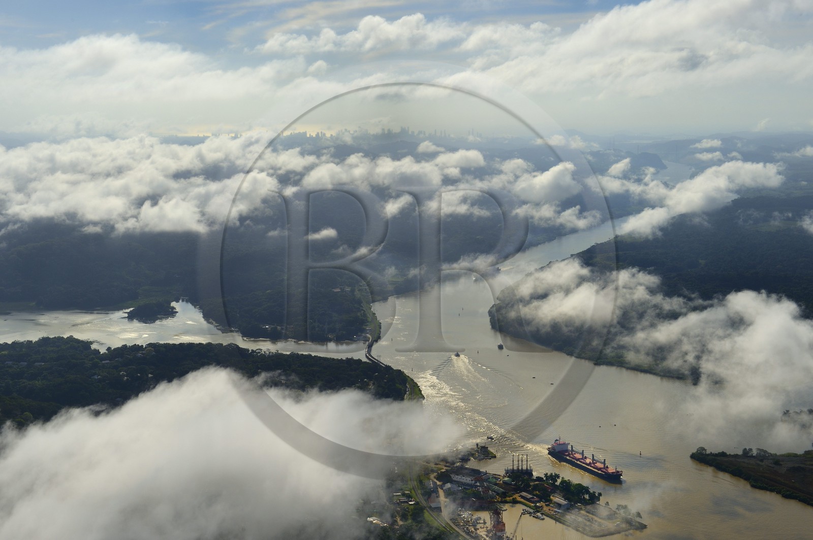 Panama, Panama Canal at Gamboa, the arm of the Chagres River which supplies the water to the canal and Gatun Lake, the Gaillard cut (or cut Culebra) and the skyline of Panama City in the background (aerial view)