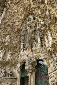 Spain, Catalonia, Barcelona, Eixample district, Sagrada Familia basilica by Catalan modernist architect Antoni Gaudi, listed as a UNESCO World Heritage Site, facade of the Nativity, the Charity Gate, the mother of God and Saint Joseph with Jesus just born