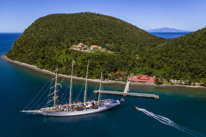 Caribbean, Dominica Island, Portsmouth, Cabrits National Park, Fort Shirley, 18th century British fort, the Star Flyer of the Star Clipper company in Prince Rupert Bay, Les Saintes in french Guadeloupe in the background (aerial view)