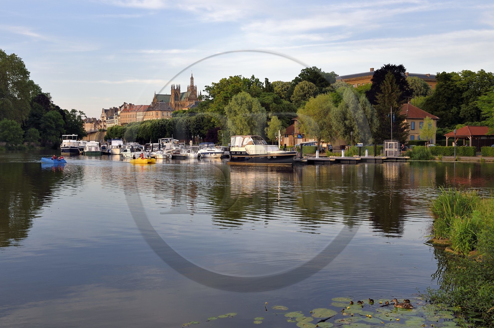 France, Moselle, Metz, Regates garden, small marina on the Moselle river and the Saint-Etienne cathedral in the background