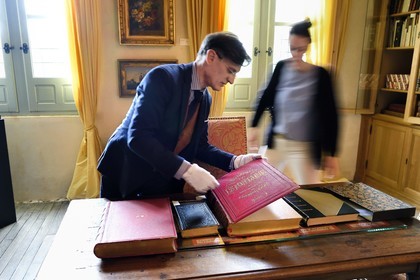 France, Aisne (02), Château-Thierry, Musée Jean de La Fontaine - Ville de Chateau-Thierry, le directeur du pole muséal Nicolas Rousseau et sa directrice adjointe Marie-Mileva Pavlovitch observant le livre des Fables de La Fontaine, édition illustrée (1867, in-folio) par Gustave Doré