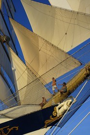 Caribbean sea, the five masted ship SPV Royal Clipper with every sail set, passengers in the front nets