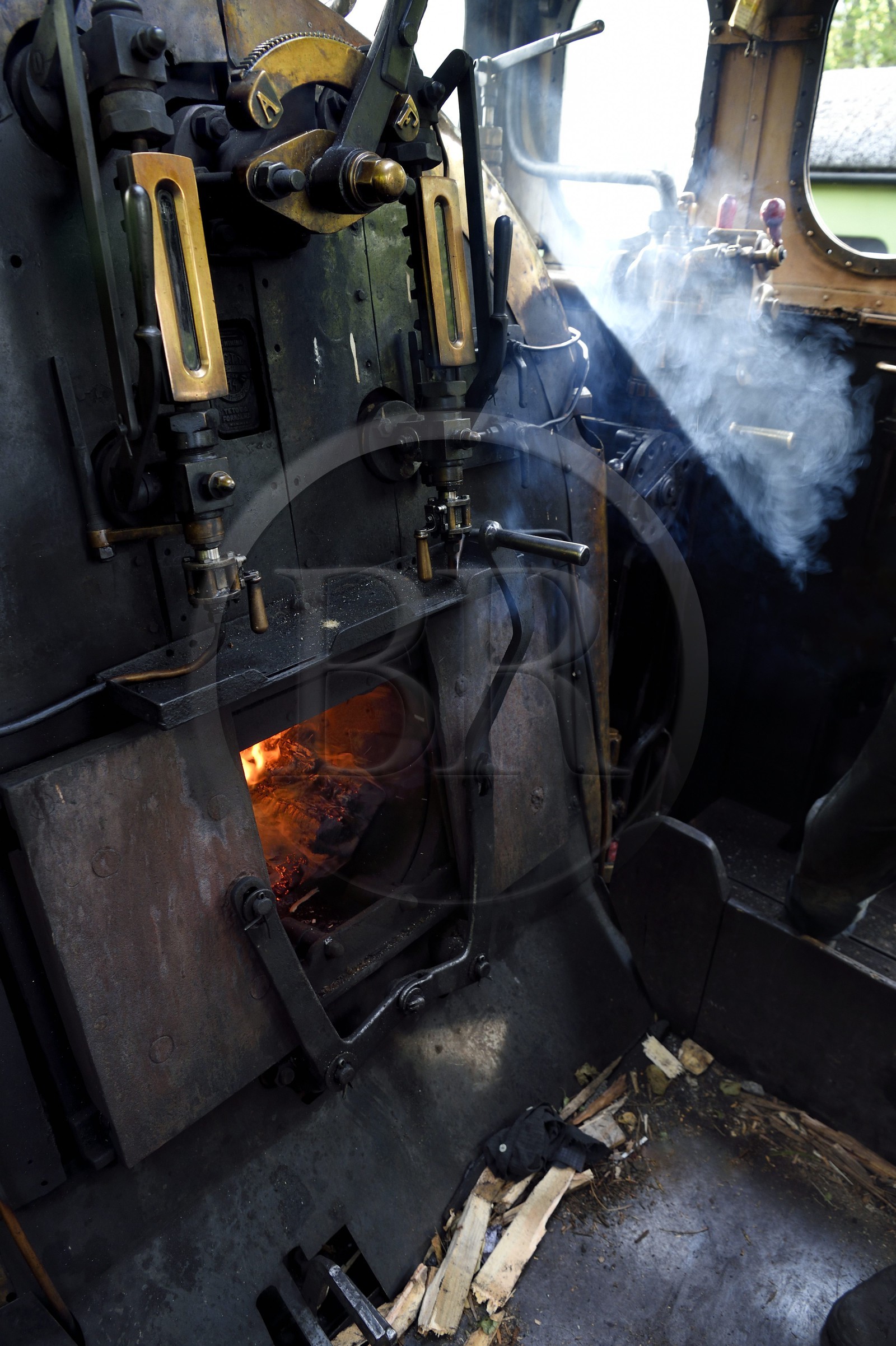 France, Alpes-Maritimes (06), Puget Théniers, le Train des Pignes, locomotive en chauffe, chargement du bois dans le geulard du foyer qui chauffe la chaudière