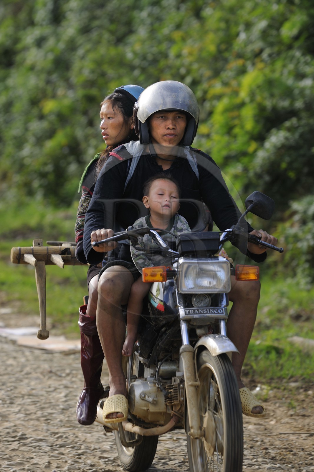 Vietnam, Lao Cai province, Sapa district, family from the Black Hmong minority group on a motorbike