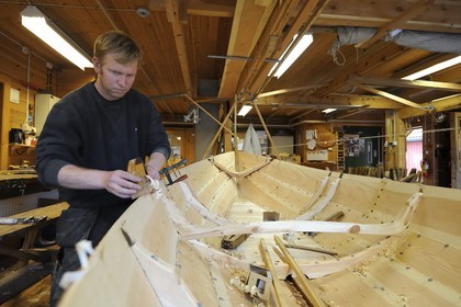 Norway, Hordaland County, Norheimsund, Fartoyvernsenter Boat Preservation Centre, renovation workshop, wooden boat with oar traditionally built by Bjorn Kvalvik