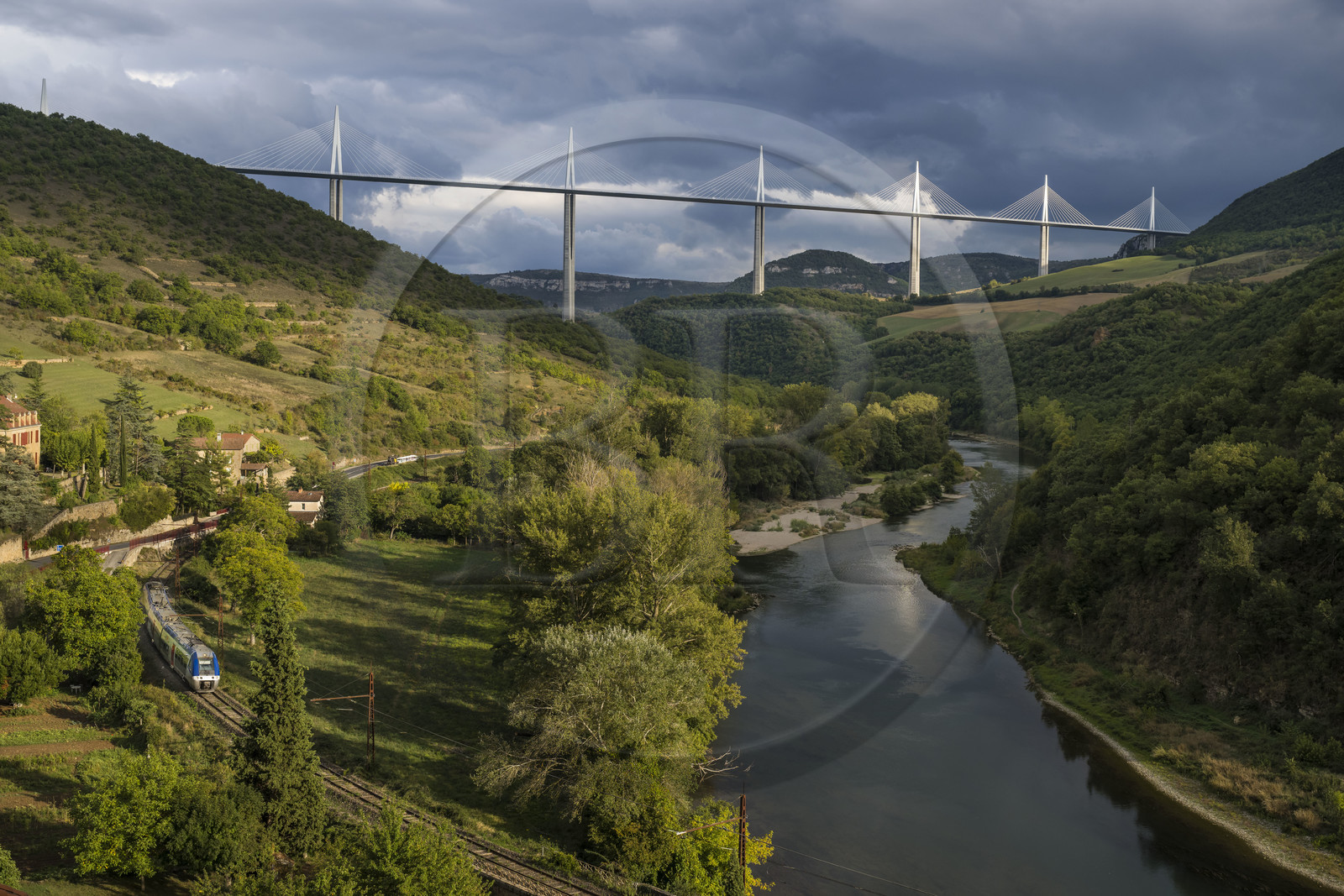 France, Aveyron, Grands Causses regional natural park, Peyre, the Millau viaduct by architects Michel Virlogeux and Norman Foster, passage of the local train along the Tarn river