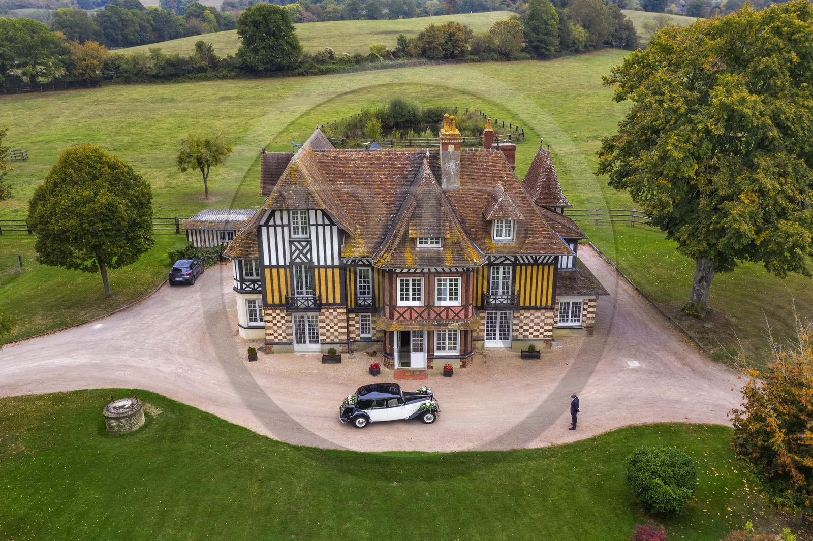 France, Calvados, Pays d'Auge, Beuvron en Auge, labelled Les Plus Beaux Villages de France (The Most Beautiful Villages of France), Manor of the Haras de Sens and 1950s vintage French Citroen Traction Avant car (aerial view)