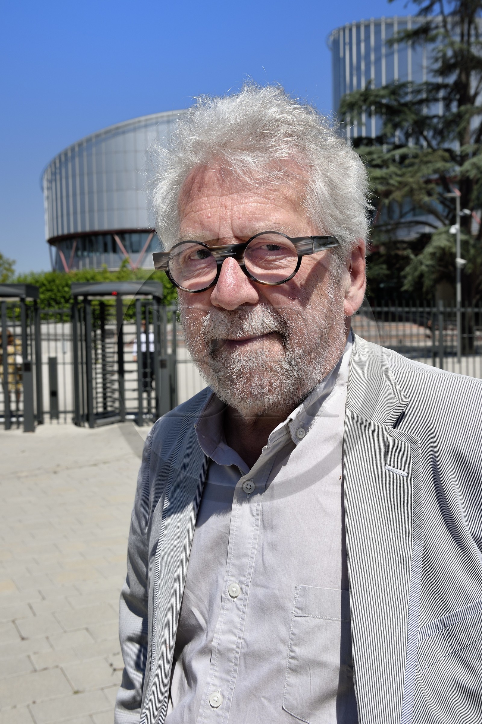 France, Bas Rhin, Strasbourg, European district, the architect Claude Bucher in front of the building of the European Court of Human Rights that he designed with the architect Richard Rogers