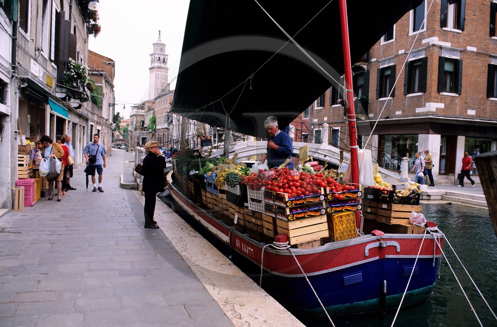 Italy, Veneto, Venice, costermonger on his boat