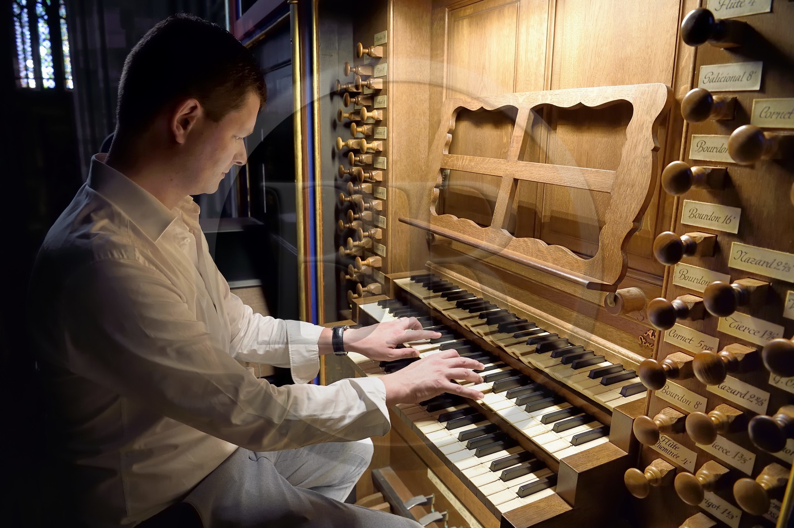 France, Bas Rhin, Strasbourg, old town listed as World Heritage by UNESCO, Notre Dame Cathedral, the organist Guillaume Nussbaum at the the great organ that dominates the nave