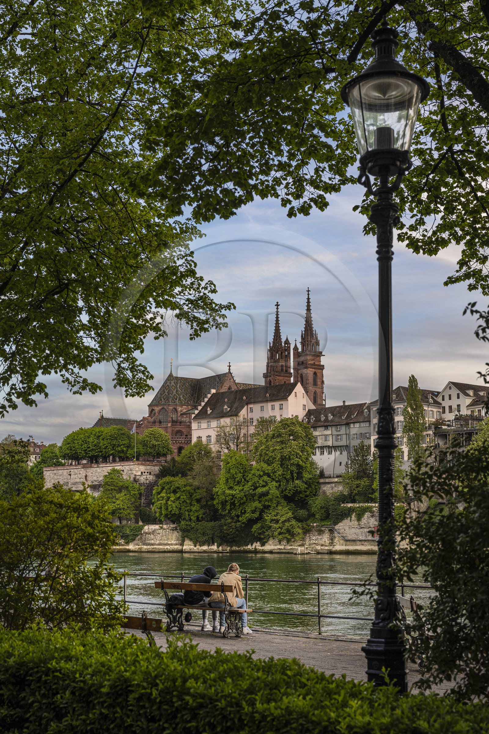 Switzerland, Canton Basel-Stadt, Basel, Little Basel district quays on the right bank of the river Rhine and the Minster or Protestant Cathedral of Our Lady of Basel (Munster) in the background