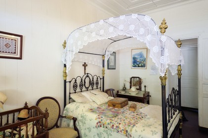 France, Reunion island (French overseas department), Cirque de Salazie, listed as World Heritage by UNESCO, Hell-Bourg, labeled labelled Les Plus Beaux Villages de France (The Most Beautiful Villages of France), the Villa or Maison Folio with the traditional Creole architecture of the 19th century, four poster bed in the bedroom