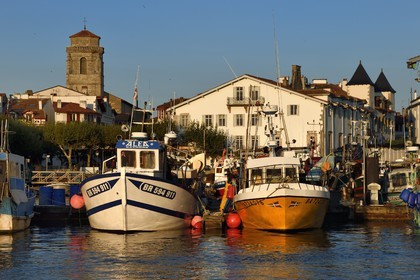 France, Pyrenees Atlantiques, Basque Country, Saint Jean de Luz, the fishing port, the Saint-Jean-Baptiste (Saint John the Baptist) Church left and the white facade of the town hall on the right