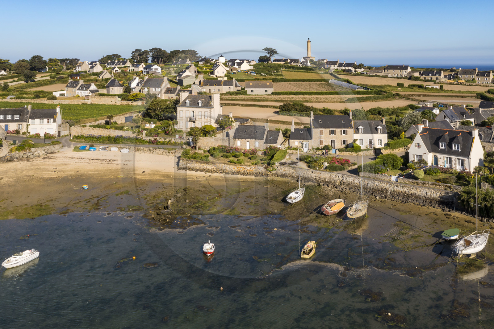 France, Finistère, Ponant Islands, Ile de Batz (Batz Island), Porz an Eog, former schooner port and shipowners' houses in the village, the lighthouse in the background (aerial view)
