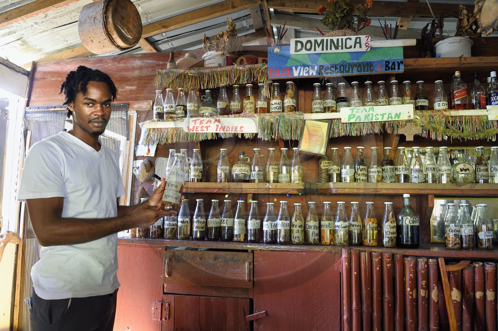 Caribbean, Dominica Island, Castle-Bruce, selection of local home-made rums at Islet View restaurant-bar